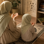 Modest Muslim mother and child sitting on a prayer mat with hands raised in dua, warm morning light filling a peaceful home.